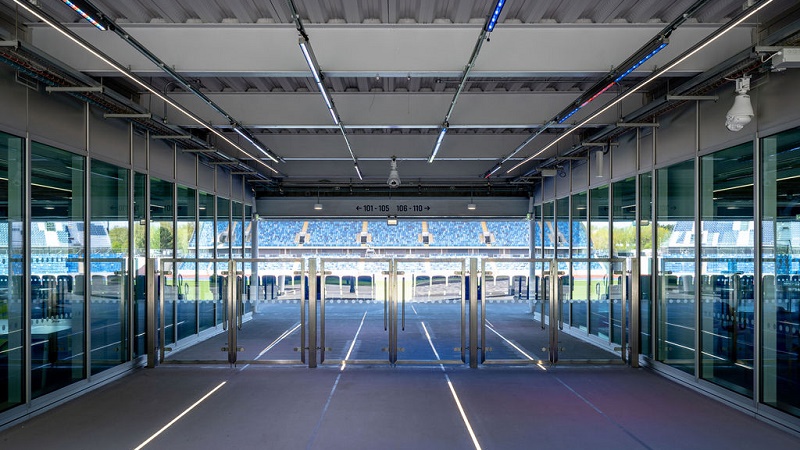 Glass walled entrance to the Stadium with airport style barriers